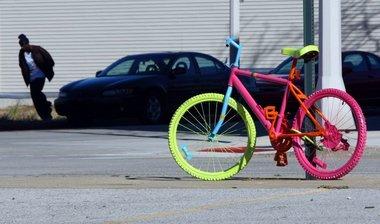 Who is painting Muskegon MI bikes in day-glo colors, and why?